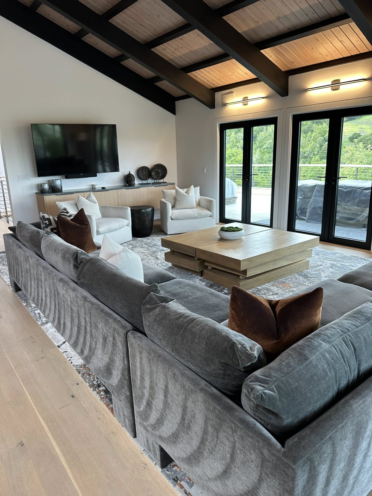 Clean modern living room with sectional sofa and hardwood floors